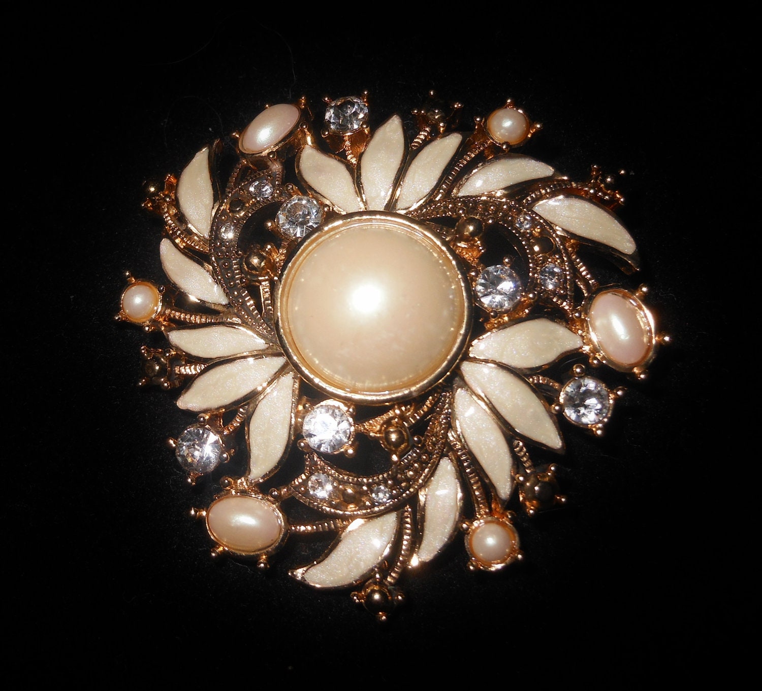 Stunning Monet creamy white pearl floral brooch with rhinestone chatons and iridescent enamel leaves. flower