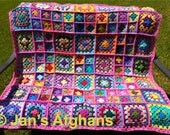 Crocheted afghan kaleidoscope granny squares with pink border