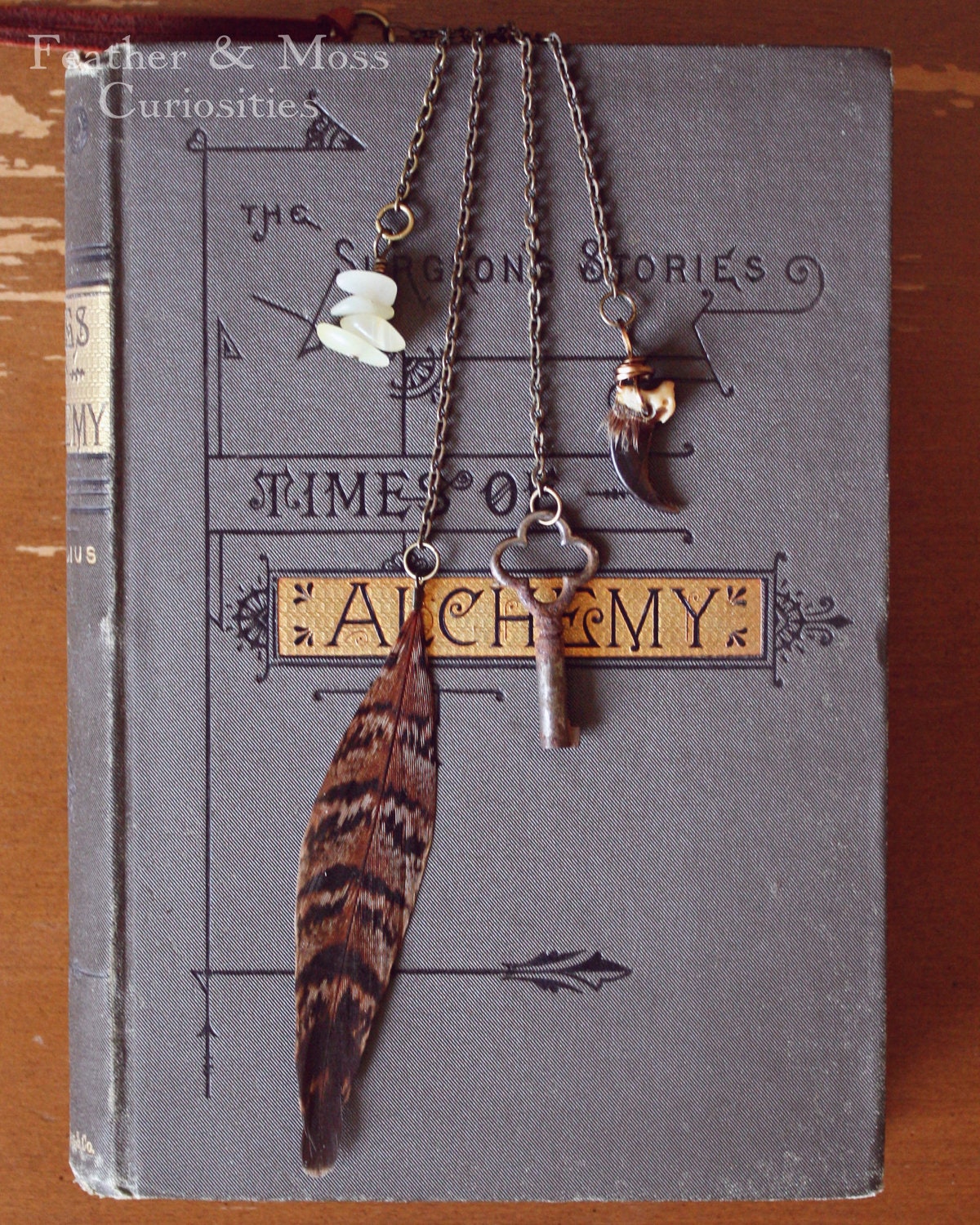 Charm and Strange Necklace Number 007. Coyote claw, yellow jade, feather, vintage key on a deerskin cord.
