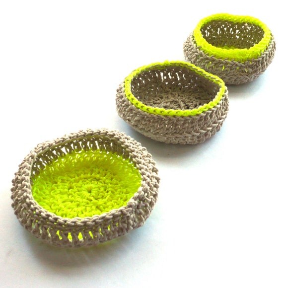 A set of three natural cotton crocheted jewellery baskets, with contrasting bright neon thread