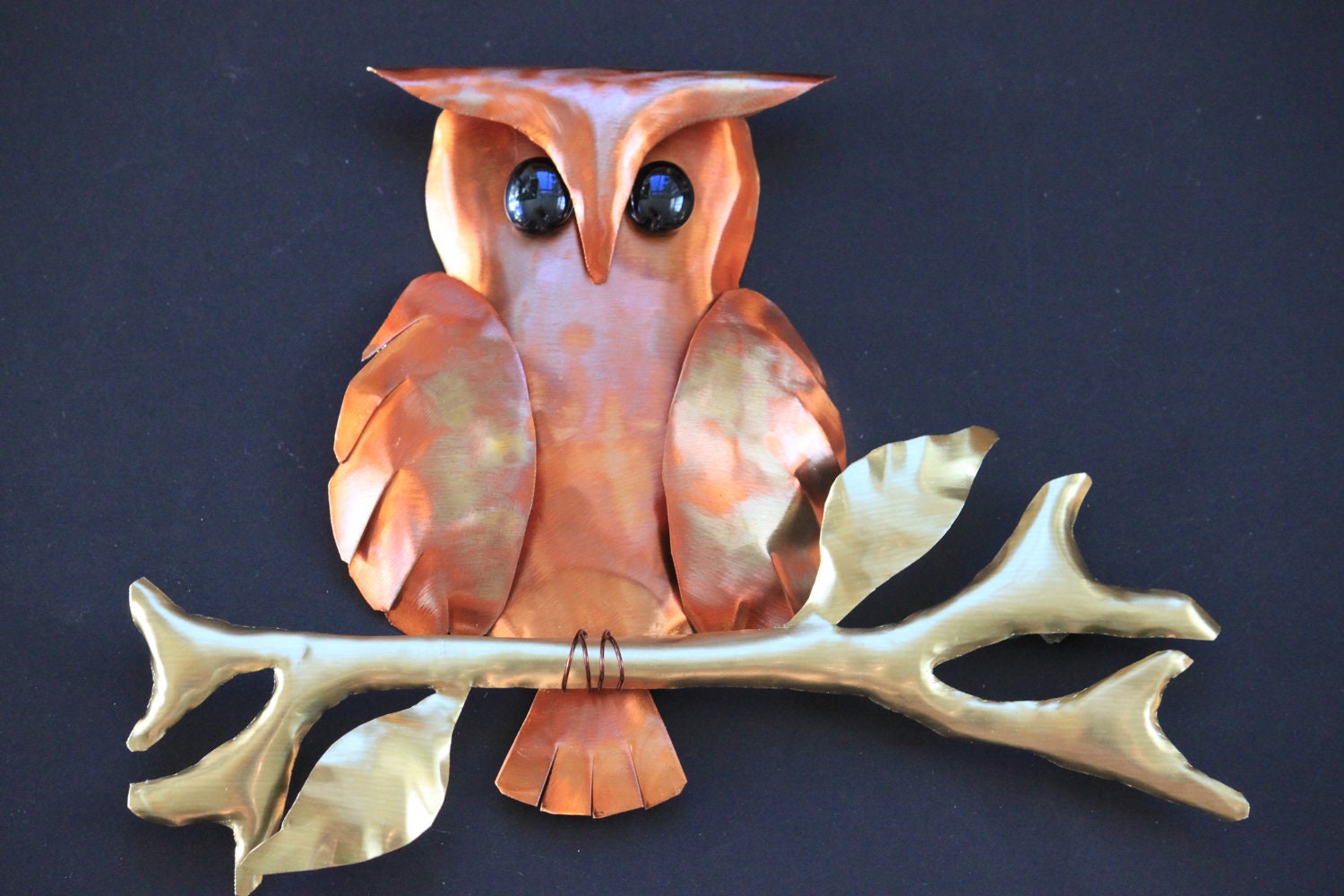 Patina copper owl sitting on brass branch