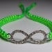 Infinity Bracelet in silver metal with rhinestones and neon green cord