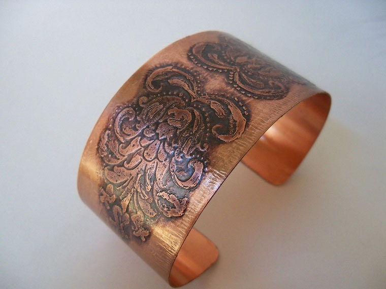 Copper cuff bracelet created from sheet metal and etched with a floral design