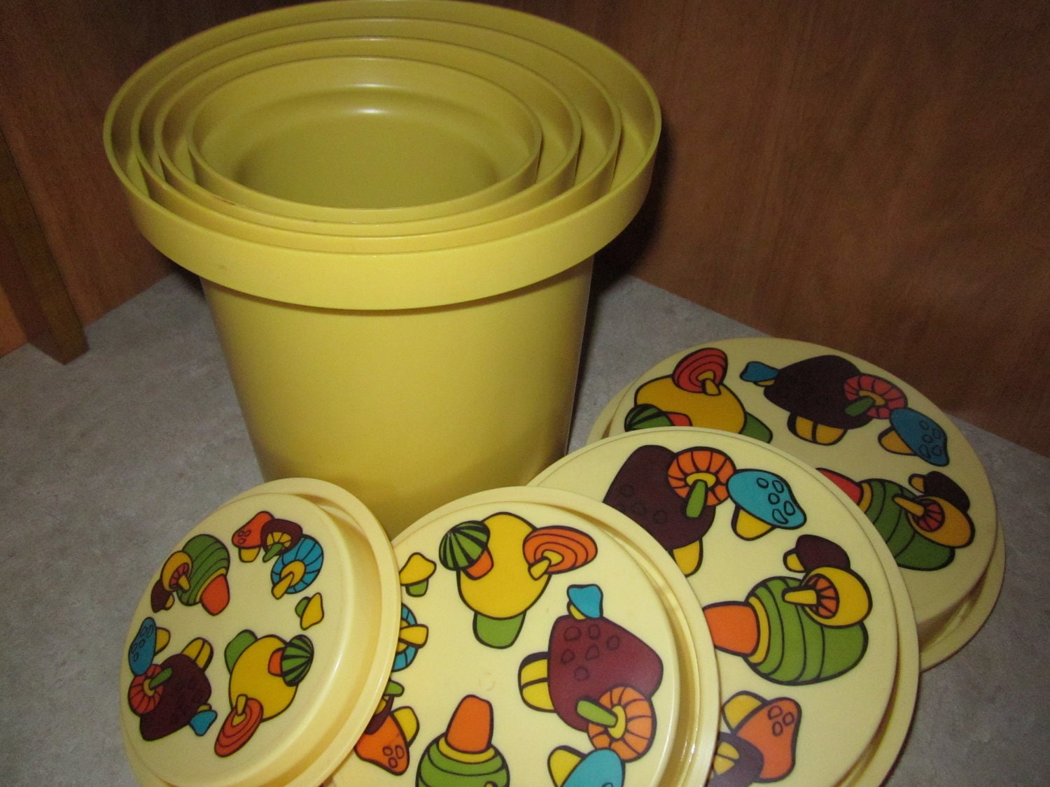 1970's Rubbermaid 8 pc nesting canister set in Harvest Gold with groovy mod mushrooms kitchen storage container