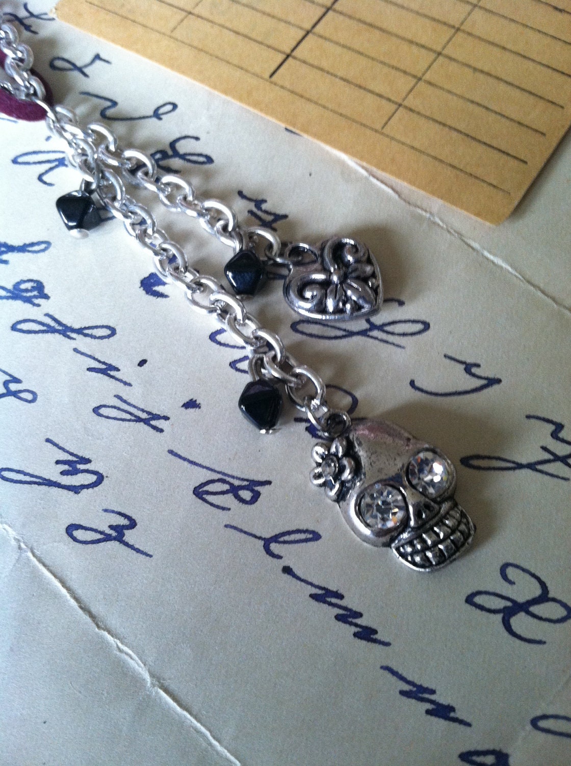 Skull and heart charm necklace, silver chain and faux suede maroon cord,