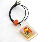 Parrot  Pendant  with orange chunky bead. Bright colour perspex pendant. Original art. Leather cord.