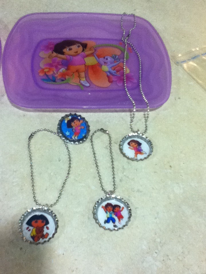 Dora Plate, Ring, 2 Bracelets and a Bottle Cap Necklace