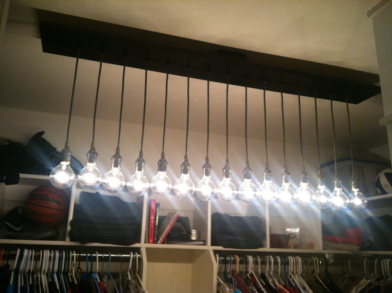 Custom Industrial Chandelier with Modern Glass Pendants in satin nickel sockets hung from rayon cord attached to premium plank base
