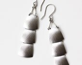 Sterling silver veil earrings of three dramatically connected trapezoid shapes each of which is textured and domed - "Drape Earrings"