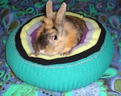 plump Ugli Donut rabbit bed for a small sized bunny hand knit turquoise lambswool