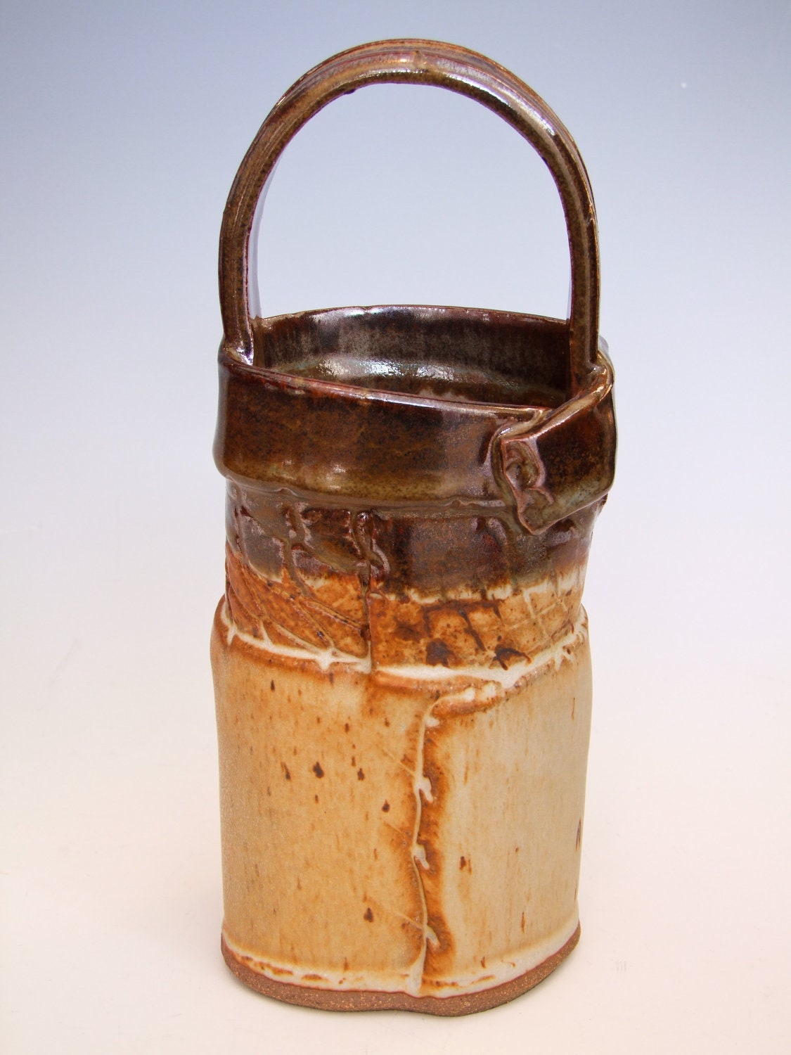 Basket. Handled. Hand Made. Ceramic/ Stoneware. Netting Texture. 9.5'' Tall. Vase. Utensil Holder. Brown and Orange/Cream.