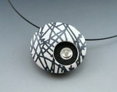 Black and White contemporary polymer clay pendant necklace with silver detail on black neckwire choker