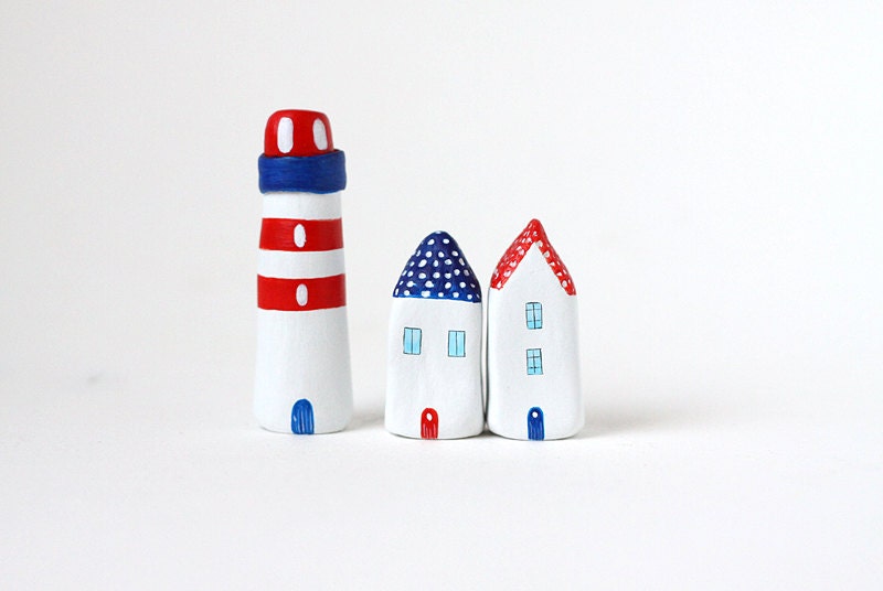 Two little clay houses and a striped lighthouse - red, white and blue