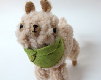 Small Wooly Alpaca in a Green Embroidered Cape