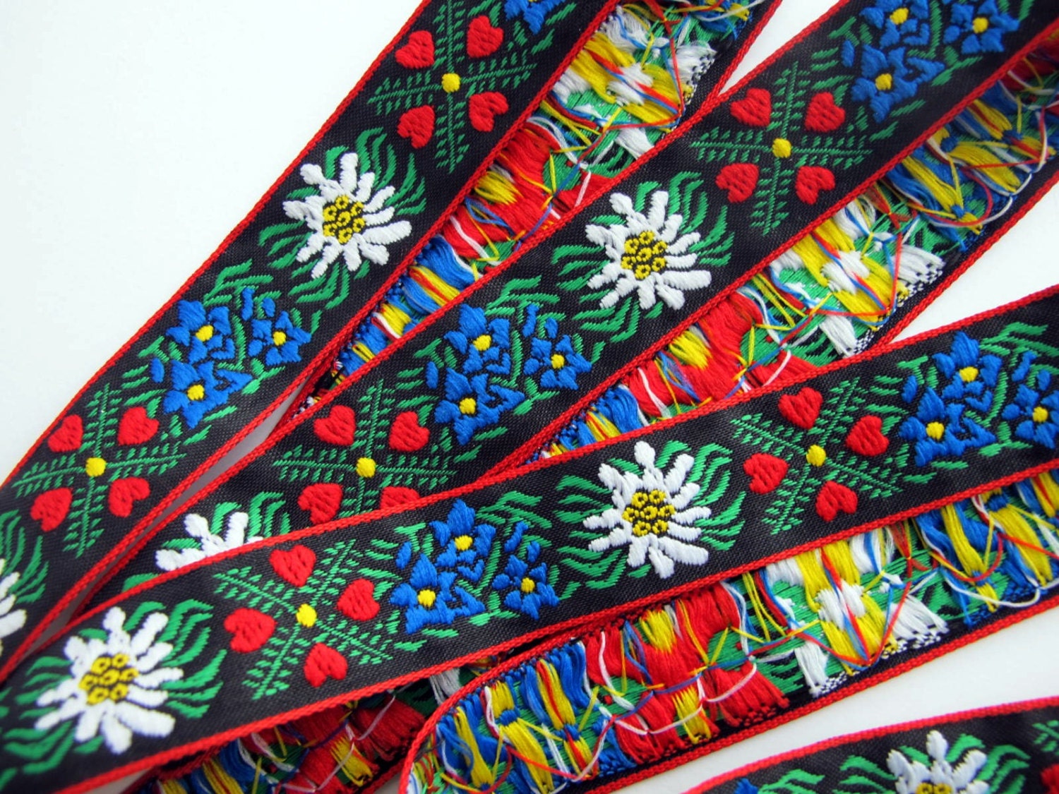 3 yard EDELWEIS & HEARTS Jacquard trim. White, Blue, red, green, yellow on black. Red edges. 1 inch wide. 949(2)-A