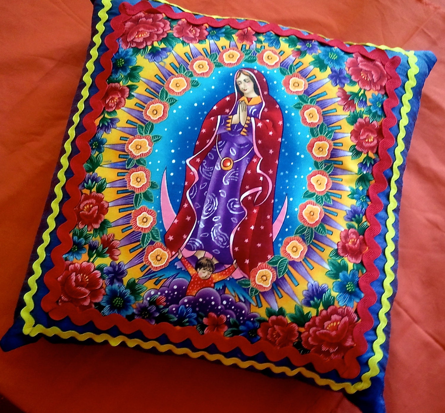 Virgen de Guadalupe, Blue, Raw Silk Pillow With Red And Yellow Ric Rac Ribbon.