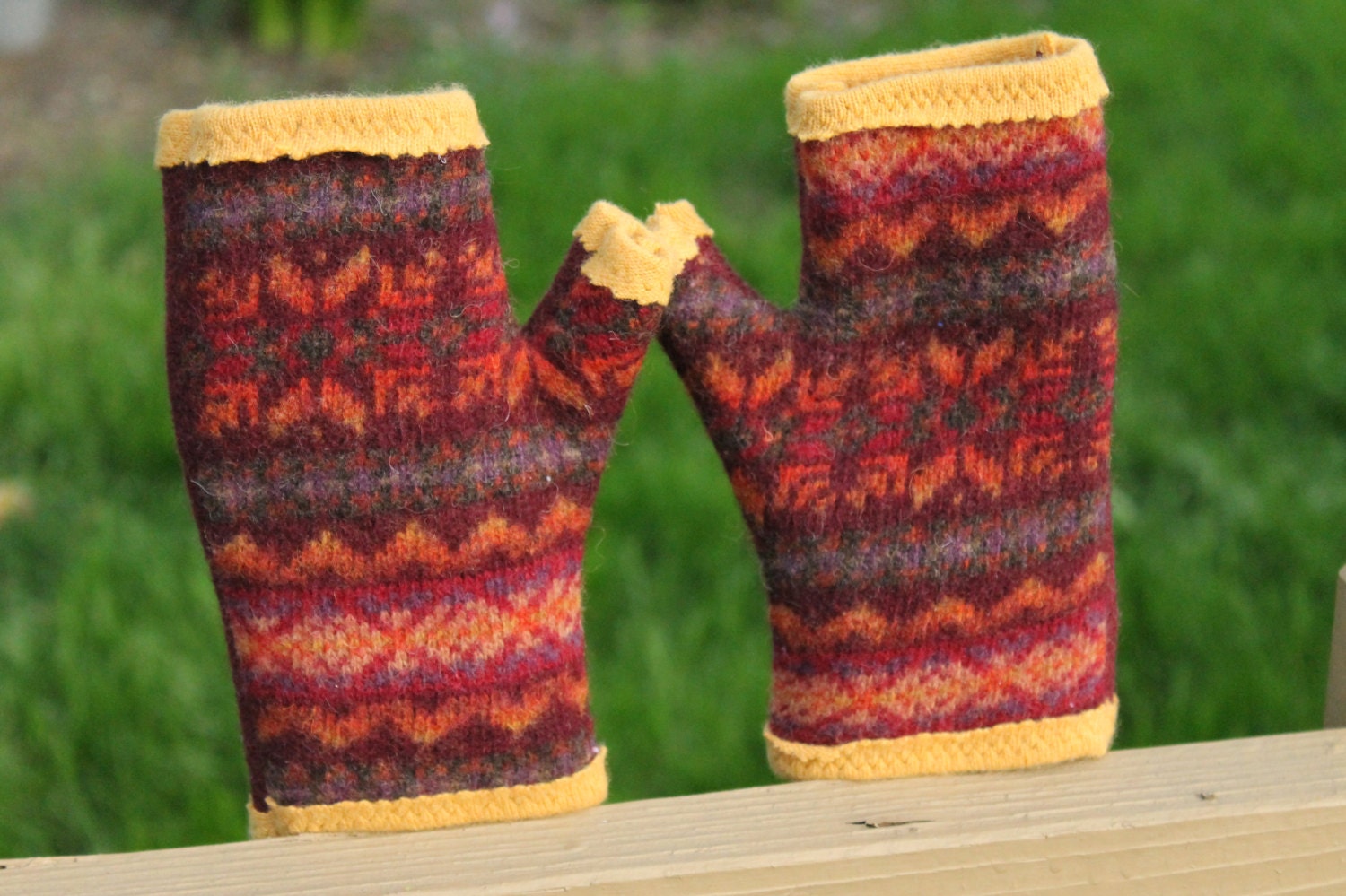 Recycled cashmere and wool fingerless gloves. Autumn splendor Fair Isle in rust, pumpkin, burgundy, and charcoal grey.  Lined in gold.