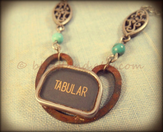 Found object necklace. Typewriter key, rusty link and turquoise. Tabular.