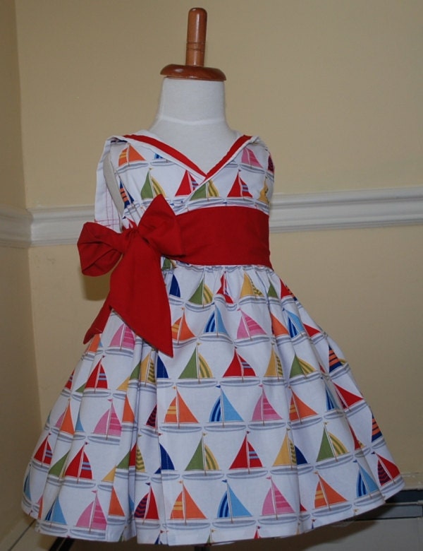Sailor dress for girls and infants in lovely sailboat print with ribboned sailor collar in wraparound style