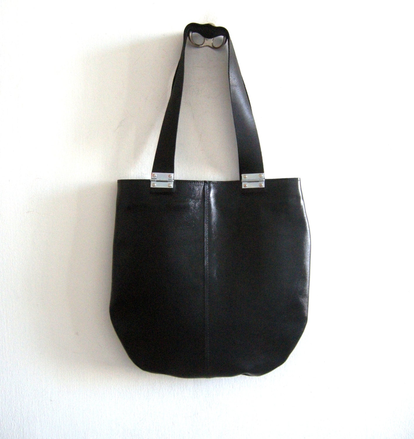 Black leather tote with black strips and hinges