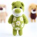 Felted miniature green pocket bear with flowers