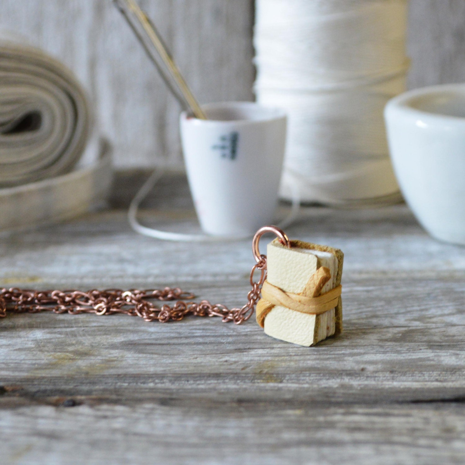 Book Necklace: Small, pale yellow tied with deerskin, reclaimed leather.