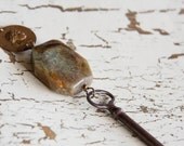 vintage skeleton key, green/brown asymmetrical stone & roman coin charm / de gama necklace
