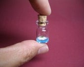 Tiny sailboat is in a tiny bottle