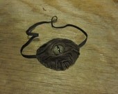 Grichels leather eyepatch - scaly chocolate brown with green speckled slit pupil reptile eye