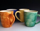 A set of four colorful mugs, coffee mugs, four colors, wheel thrown, stoneware mug set