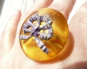 Perrine statement amber colored cocktail ring - large domed plastic disc with metallic bow - eco fiendly repurposed vintage