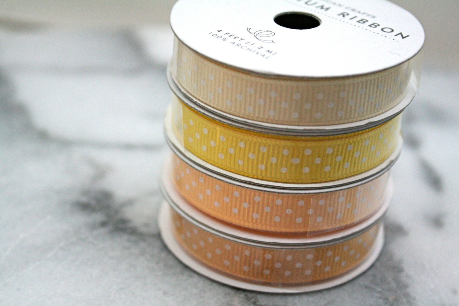 Grosgrain ribbon, yellow and gold.  American Crafts Premium Ribbon, four spools, 4 feet each.  Polka dot craft ribbon.