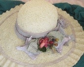 Summer straw hat with light purple accents shaped by hand for wedding or garden party