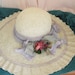 Summer straw hat with light purple accents shaped by hand for wedding or garden party