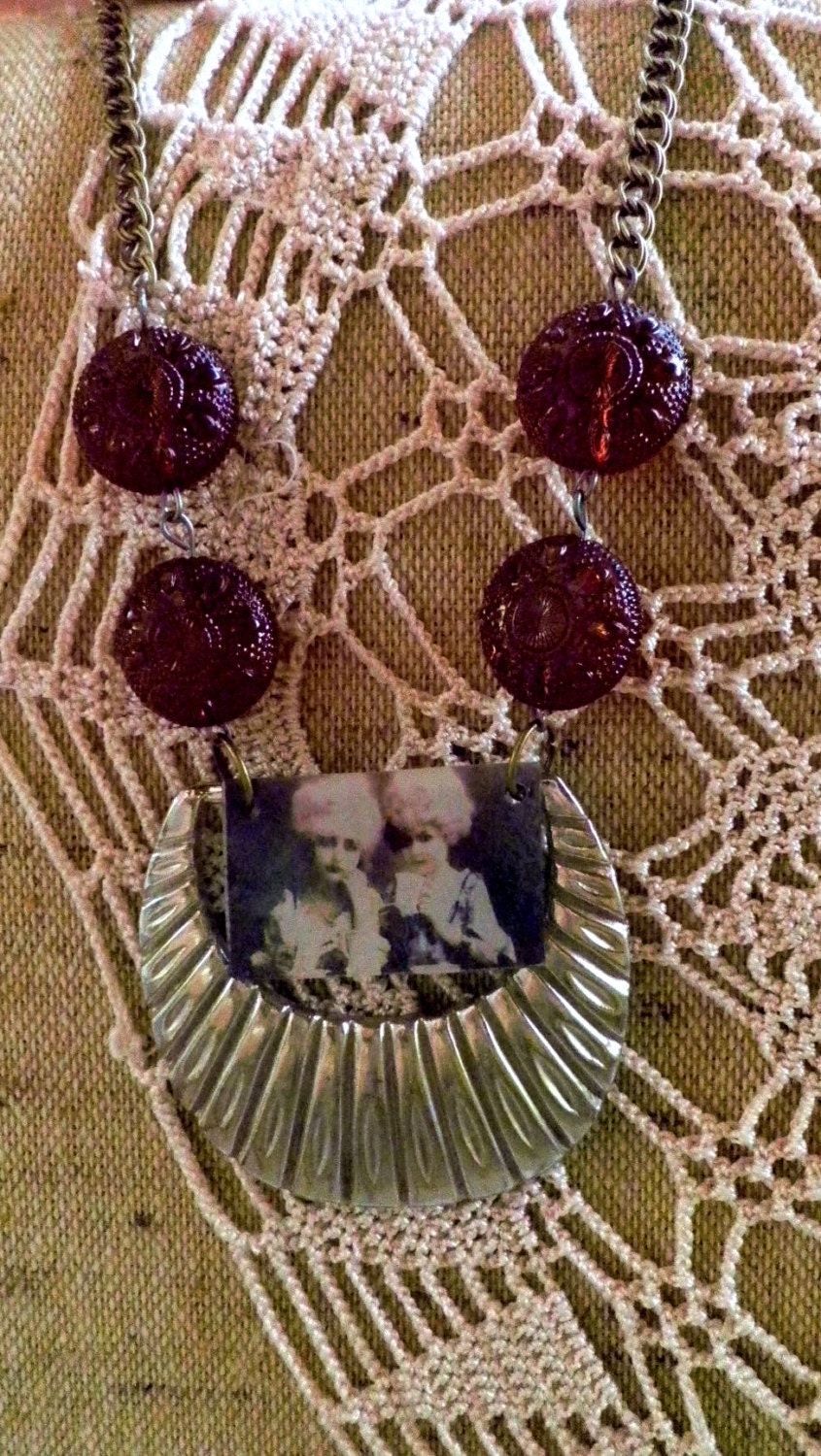 Edgy buckle necklace with french girls in pink wigs.