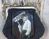 Pendant with charming coin purse and "PARIS" theme center and chunky chain.