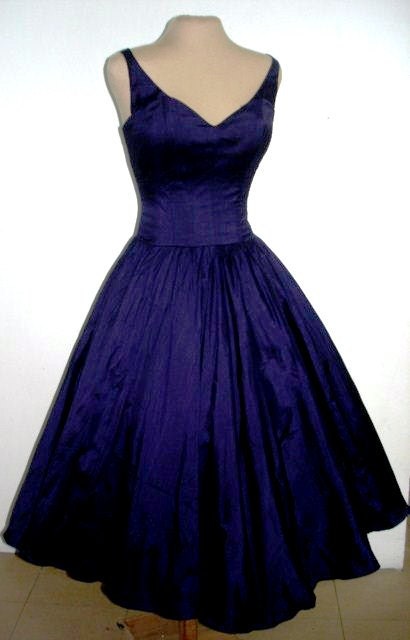 A sexy yet elegant 50s style cocktail dress in gorgeous deep blue satin