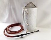 French enamel flat back container with hose and bakelite tap, originally for medical use but great for putting flowers in.
