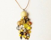 Contemporary bead pendant, yellow, grey, silver, funky, boho, tribal, tassel, random, abstract.