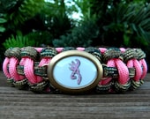 Rose Pink/Multi Cam Paracord Bracelet with a Pink and Camo Buck Image Gold Tone Charm-Wrist Measurement Required Please Read Listing Details
