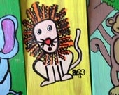 Little lion man in yellow on wooden block 