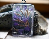 resin pendant. purple floating flowers in a rectangle drill set pendant. lavender geometry.