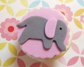 Elephant fondant cupcake toppers on pink scalloped background for new baby girl boy first birthday