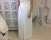 Capped sleeves, low scooped back with rosette trim and train. French lace and silk chiffon wedding dress