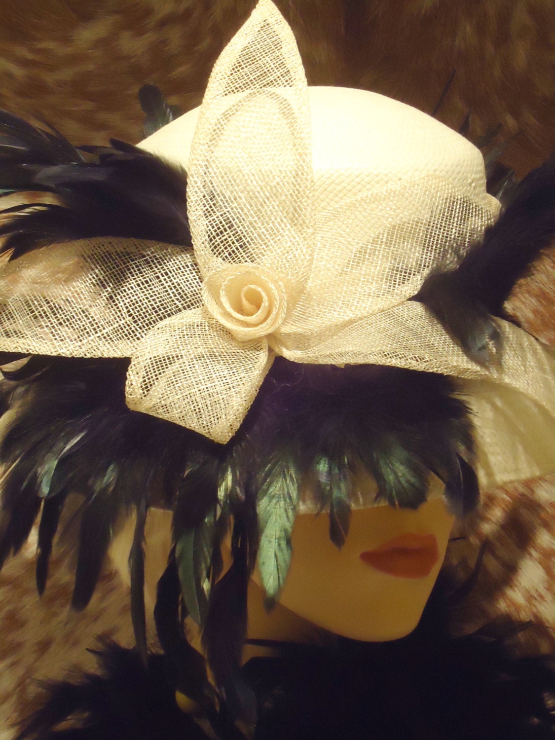Wedding Couture Fascinator. Cream with net flower front and black plume feather surround.
