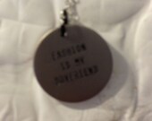 cast metal charm reading, "fashionismyboyfriend"
