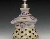 white and light yellow with polka dots and pink / purple circles soap / lotion pump dispenser