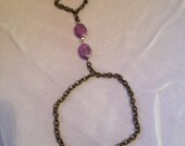 Wrist-finger bracelet with purple beads