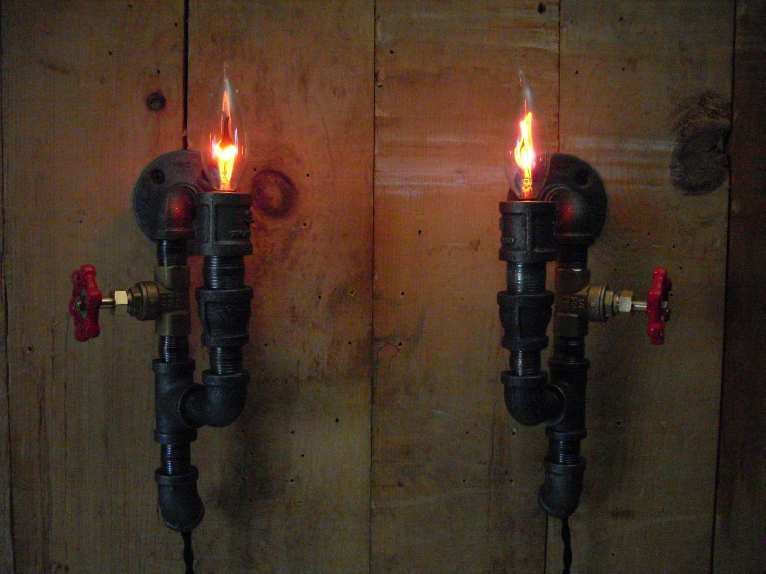 Bookend wall sconces, unique matching, steampunk industrial metal pipe with a flicker flame light bulb.