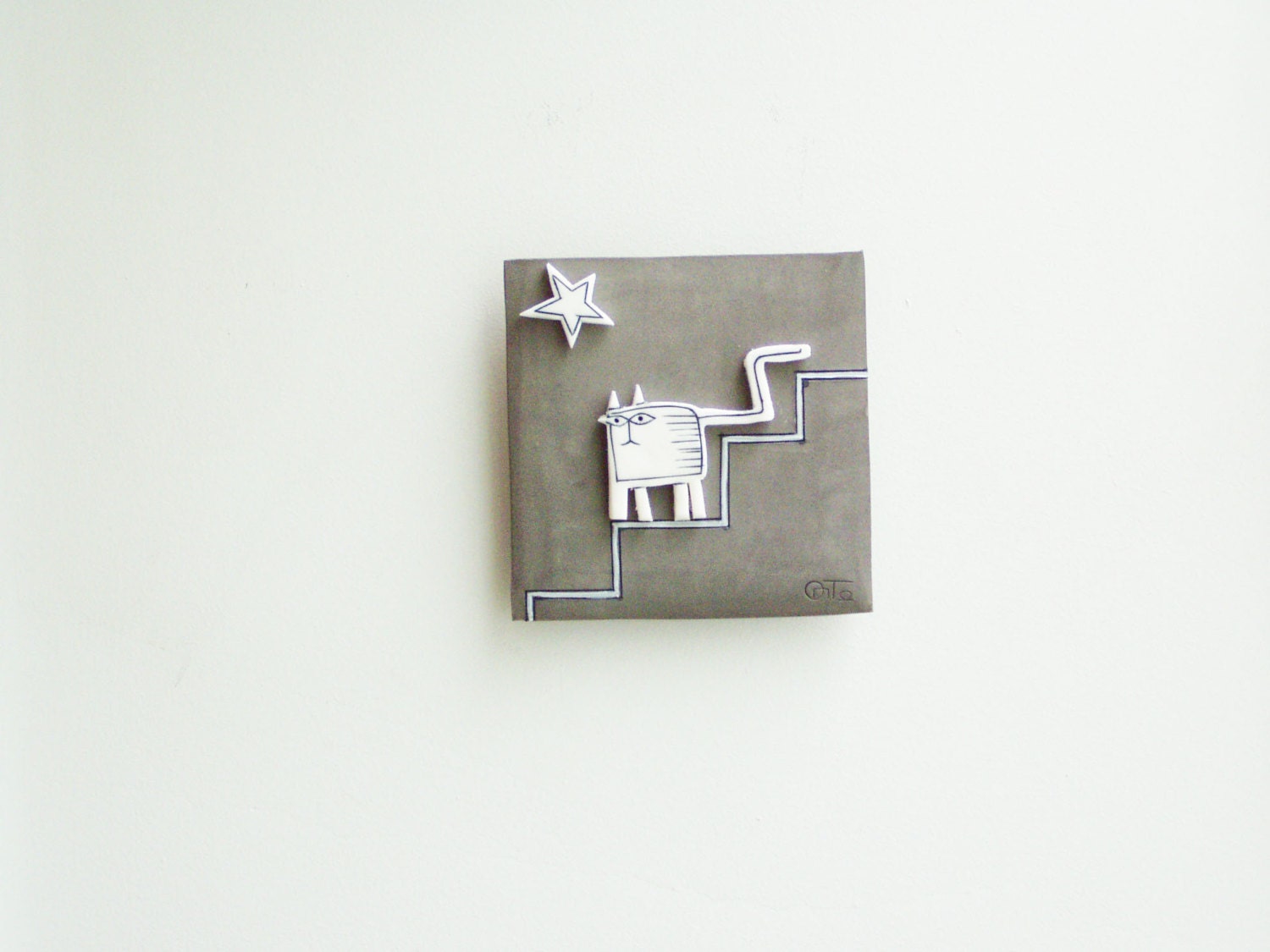 White cat wall hanging, ceramic cat in grey background, square shaped wall tile of stoneware and porcelain